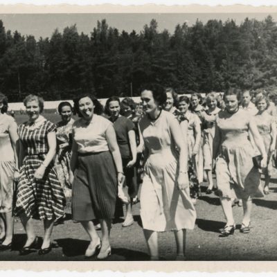 Kolonoje į estradą eina Šilutės rajoninių kultūros namų dainininkės.